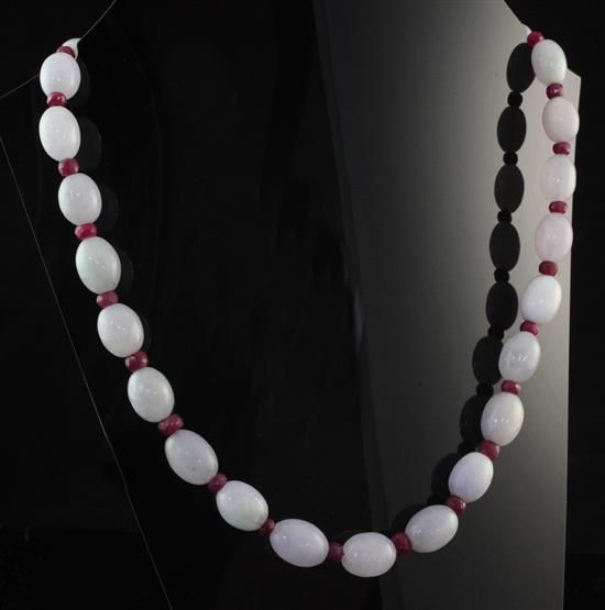 A single strand graduated oval jadeite bead necklace, 18in.